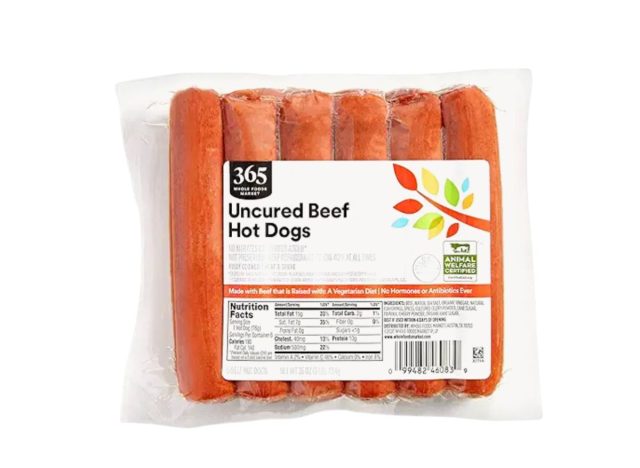 package of Whole Foods hot dogs on a white background