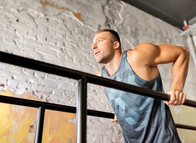 fit, muscular man doing tricep dips, concept of bodyweight exercises for men to build a fit upper body