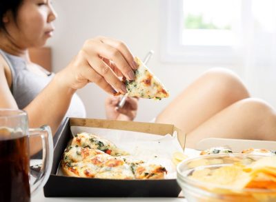 woman eating pizza