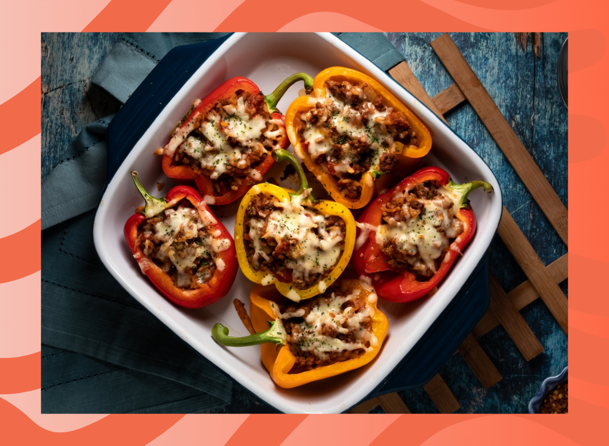 dish of stuffed bell peppers on a red background