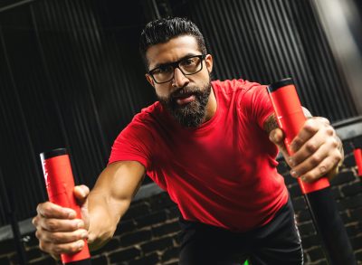 middle-aged man doing sled pushes