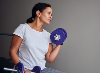 woman doing bicep curls, concept of strength exercises for women