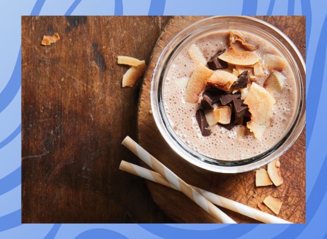 photo of a coconut chocolate smoothie in a glass on a wood table