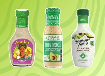 three bottles of salad dressings on a green background