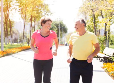 older couple running on street