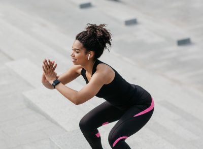 woman doing jump squats, concept of exercises to melt love handles