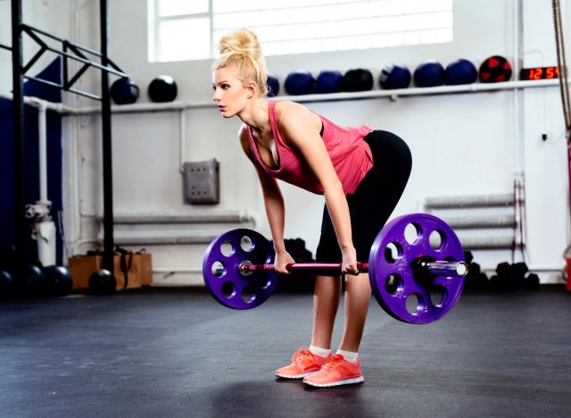 woman doing deadlift at the gym, concept of exercises to build muscle and melt fat