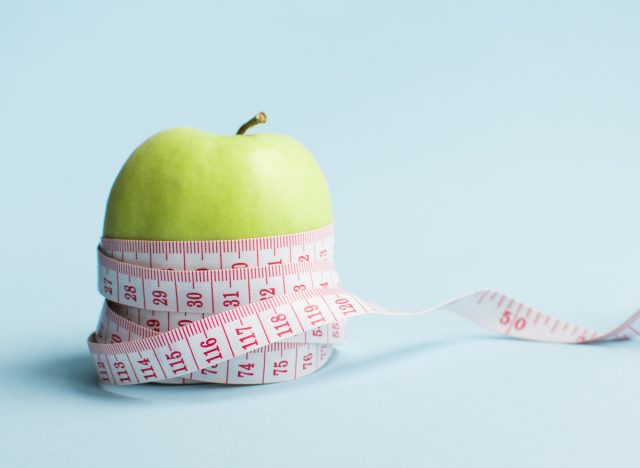 apple weight loss concept with measuring tape