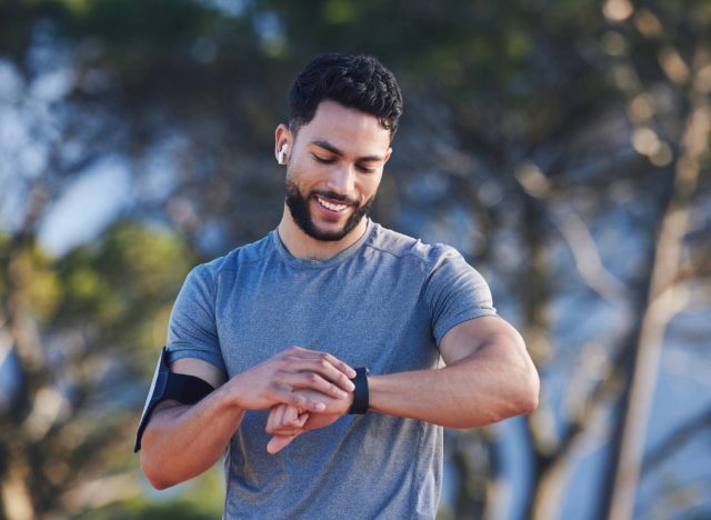 fitness man checking watch, concept of exercising for 30 minutes