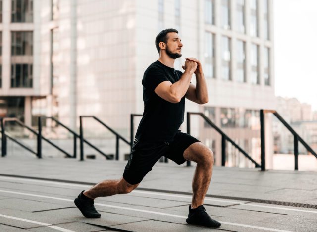 fit man doing walking lunges, no equipment workout concept for men to gain muscle and strength