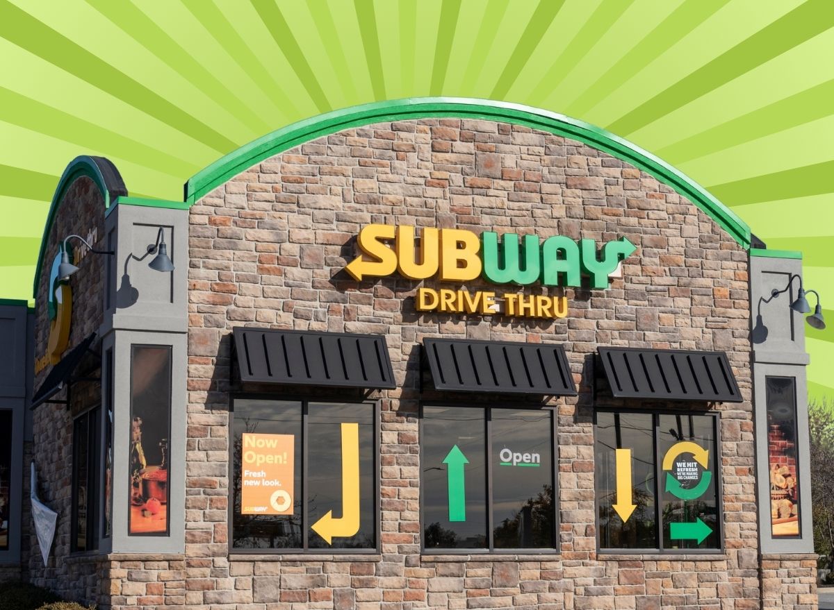 The storefront of a Subway restaurant against a colorful background