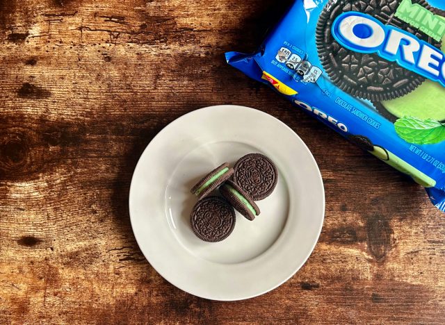 mint oreos on a plate next to a package of mint oreos