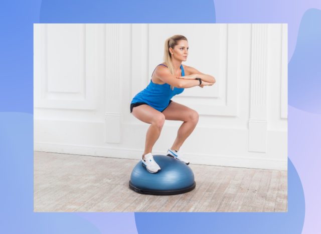 fit blonde woman doing bosu ball squats in bright room