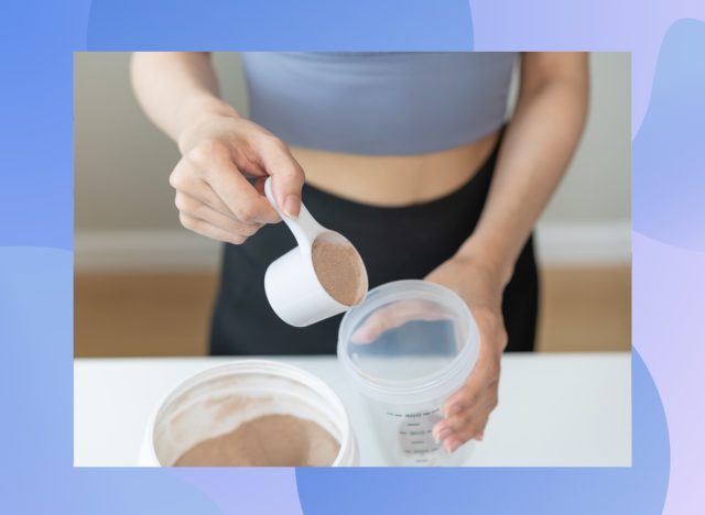 close-up of woman's hands scooping protein powder into a cup to make a smoothie