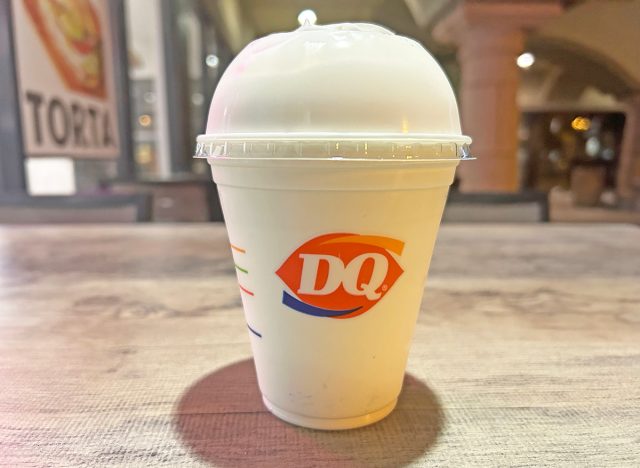 A vanilla milkshake in a white cup from Dairy Queen