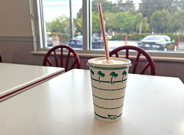 A vanilla milkshake in a palm tree-designed cup from In-N-Out