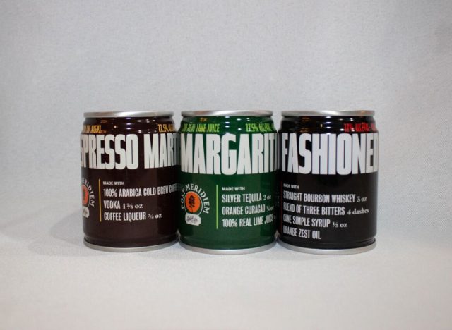 three cans of Post Meridiem cocktails on a white background