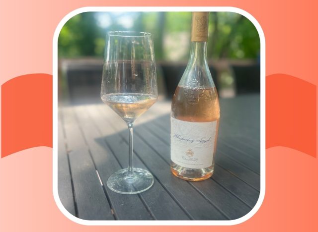 a bottle and glass of whispering angel rose on an outdoor table 