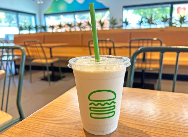A vanilla milkshake in a see-through cup from Shake Shack