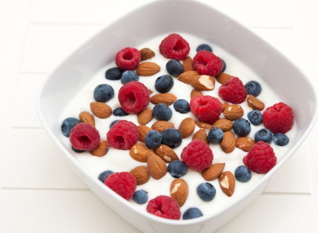bowl of yogurt topped with berries and almonds