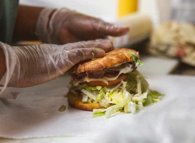 a person making a sandwich at alvin ord's