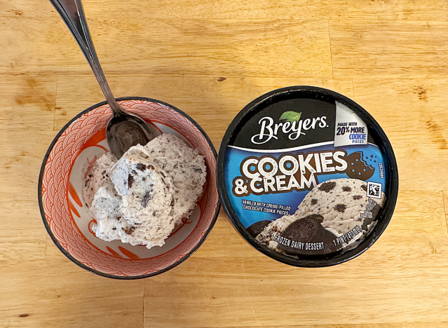 a container of breyers next to a bowl of ice cream 