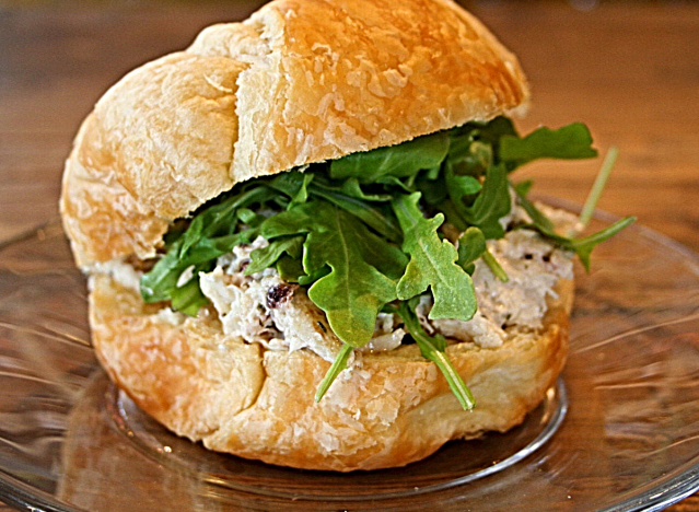 a chicken salad sandwich on a croissant