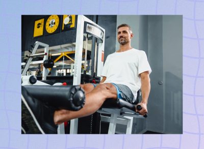 fit, happy man using the leg curl machine at the gym