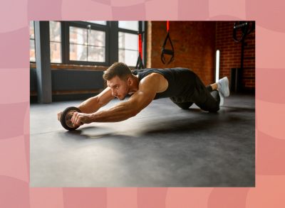 man performing ab rollout in the gym