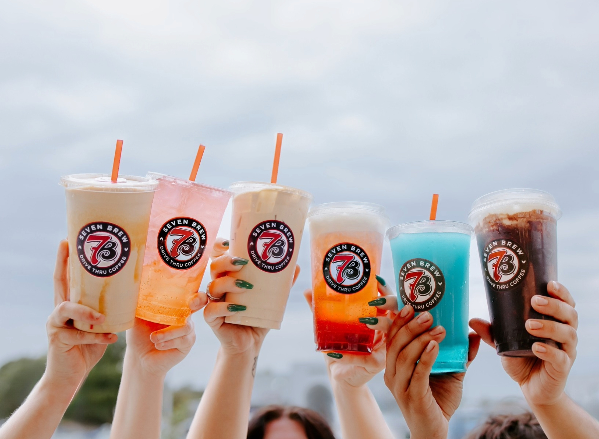 people holding 7 brew coffee drinks