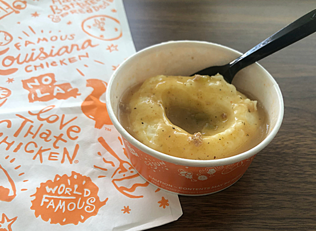 a cup of popeyes mashed potatoes 