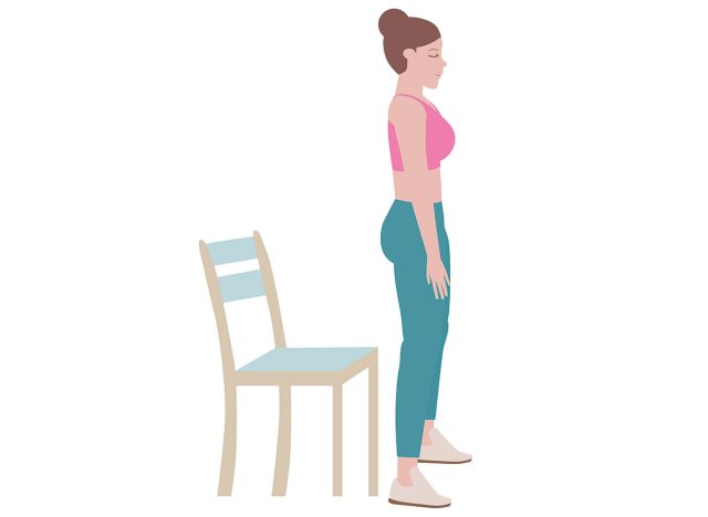 Woman standing in front of a chair 