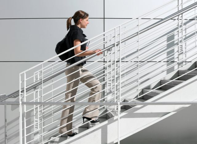 work woman taking stairs