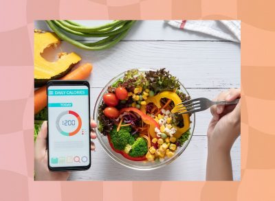 1,200-calorie diet concept, woman eating salad and checking calorie count on an app on her phone