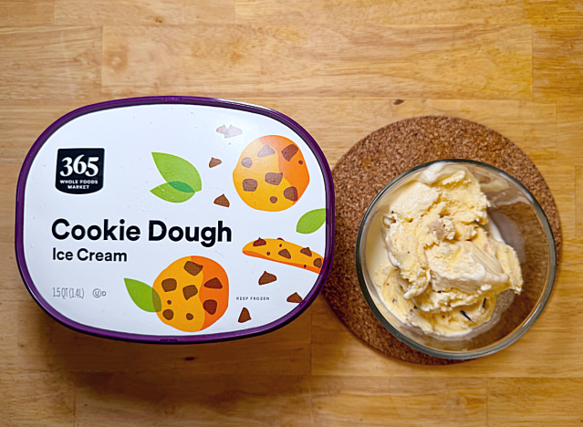 365 cookie dough ice cream container next to a bowl of it 