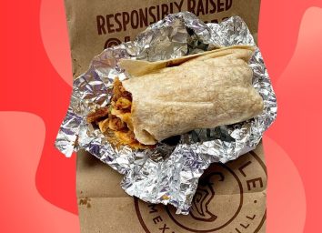 Chipotle burrito unwrapped on red background