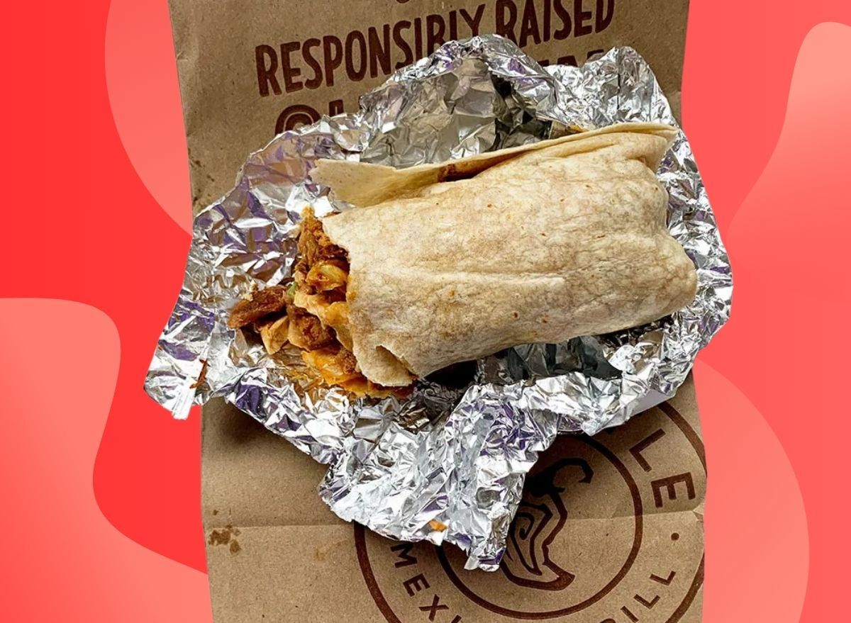 Chipotle burrito unwrapped on red background