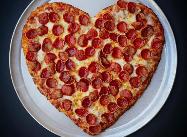 a heart shaped pizza on a tray from mountain mike's pizza