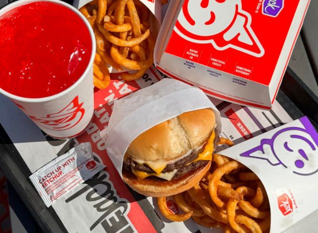 Jack in the Box burger, fries, and drink on a table