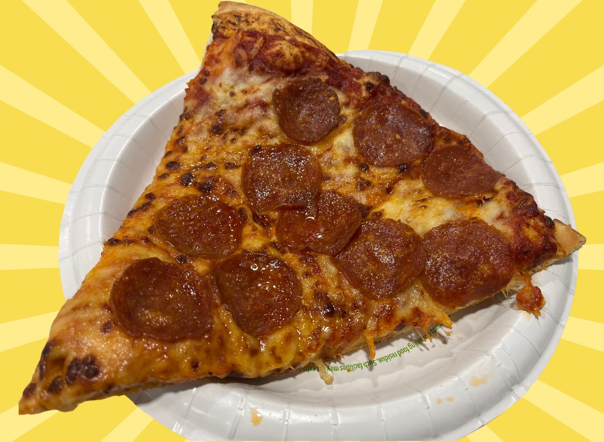 A slice of pepperoni pizza from Costco set against a vibrant background.