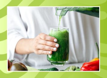 person pouring green smoothie from blender