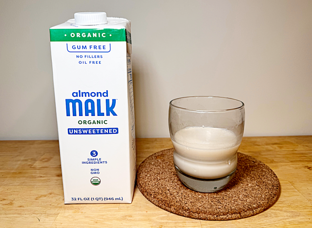 almond malk container with a glass of almond malk 