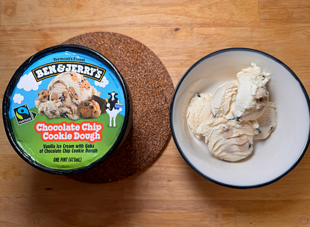 a container of ben and jerry's cookie dough ice cream next to a bowl of ice cream