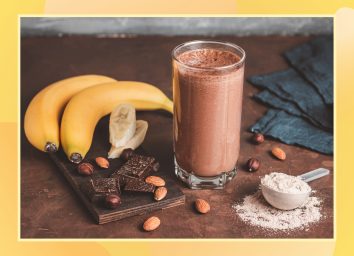 chocolate protein shake made with banana almonds and protein powder on a wooden table