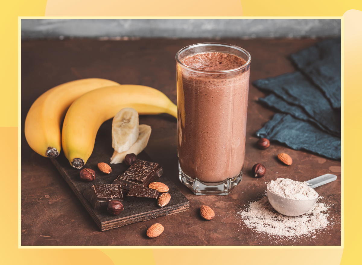 chocolate protein shake made with banana almonds and protein powder on a wooden table