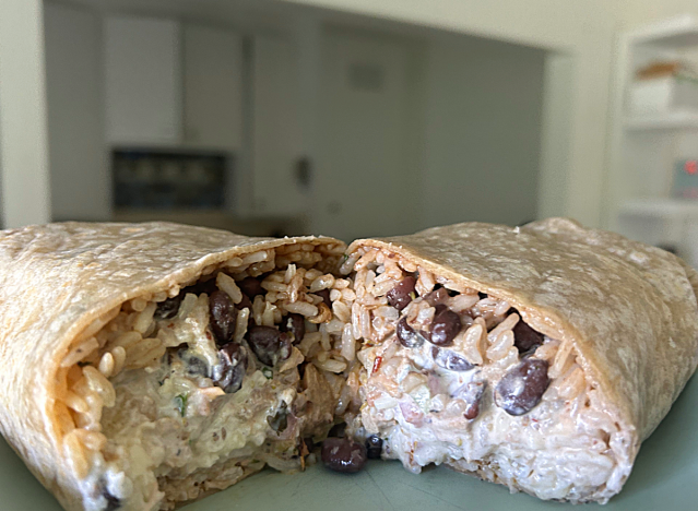 chipotle chicken burrito cut open on a counter 