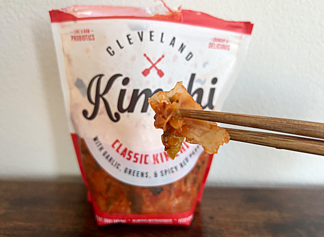 a bag of Cleveland kimchi with chopsticks holding kimchi
