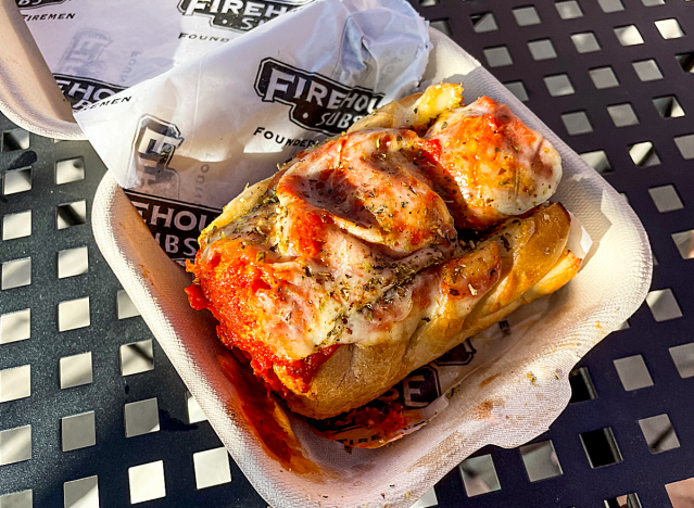 a meatball sub in a takeout container from firehouse subs