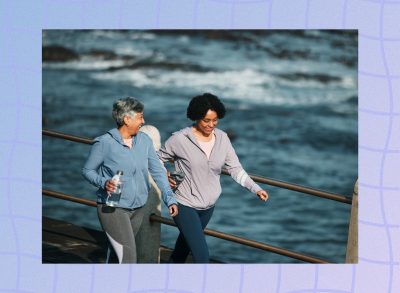 happy friends walking on boardwalk for exercise on cool, sunny day