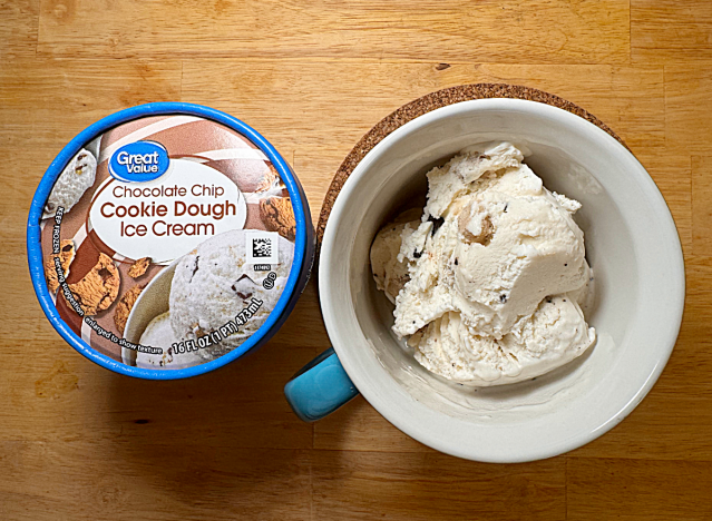 a container of great value cookie dough ice cream next to a bowl of it 